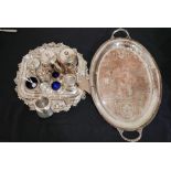 A collection of silver-plated items to include trays, a salver, salt cellars with blue glass linings