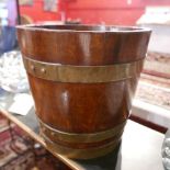 An early 20th Century oak and brass bound coopered bucket, H.29cm