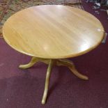 An Ercol for John Lewis elm circular table, on turned supports and four outswept legs, H.73cm