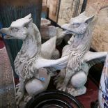 A pair of reconstituted stone Griffins, seated on square bases, H.74cm (2)