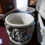 A pair of reconstituted stone planters, decorated with a procession of cherubs, H.33cm Diameter 41cm