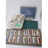 A collection of vintage cigarette cards, post cards and stamps