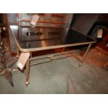 A mid century French low table, with a smoked glass top over gilt metal stretchered supports, H.42cm