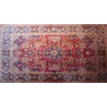 A Central Persian Kashan carpet, 343cm X 232cm. Central double pendent medallion with repeating