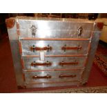 An aviator style aluminium and leather bound chest, with lift up lid over three drawers, H.80cm W.