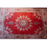 A North East Persian Meshad carpet, 373cm X 297cm. Central double pendent medallion on a rouge field
