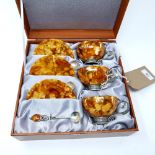 A set of three Russian silver and natural amber cups and saucers, with spoons, in original box