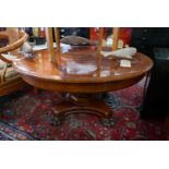 A Georgian style mahogany and marquetry inlaid circular low table, raised on a quadraform base