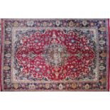 A North West Persian Sarouk rug, 193cm X 140cm. Double pendent medallion with repeating petal motifs