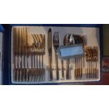A contemporary rose gold coloured canteen of cutlery in a blue case