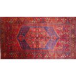 A North West Persian Zanjan Rug, 213cm X 135cm. Central diamond medallion on a rouge field within