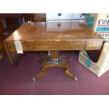 An early 19th century Regency rosewood and brass inlaid sofa table, the drop flapped top raised on a