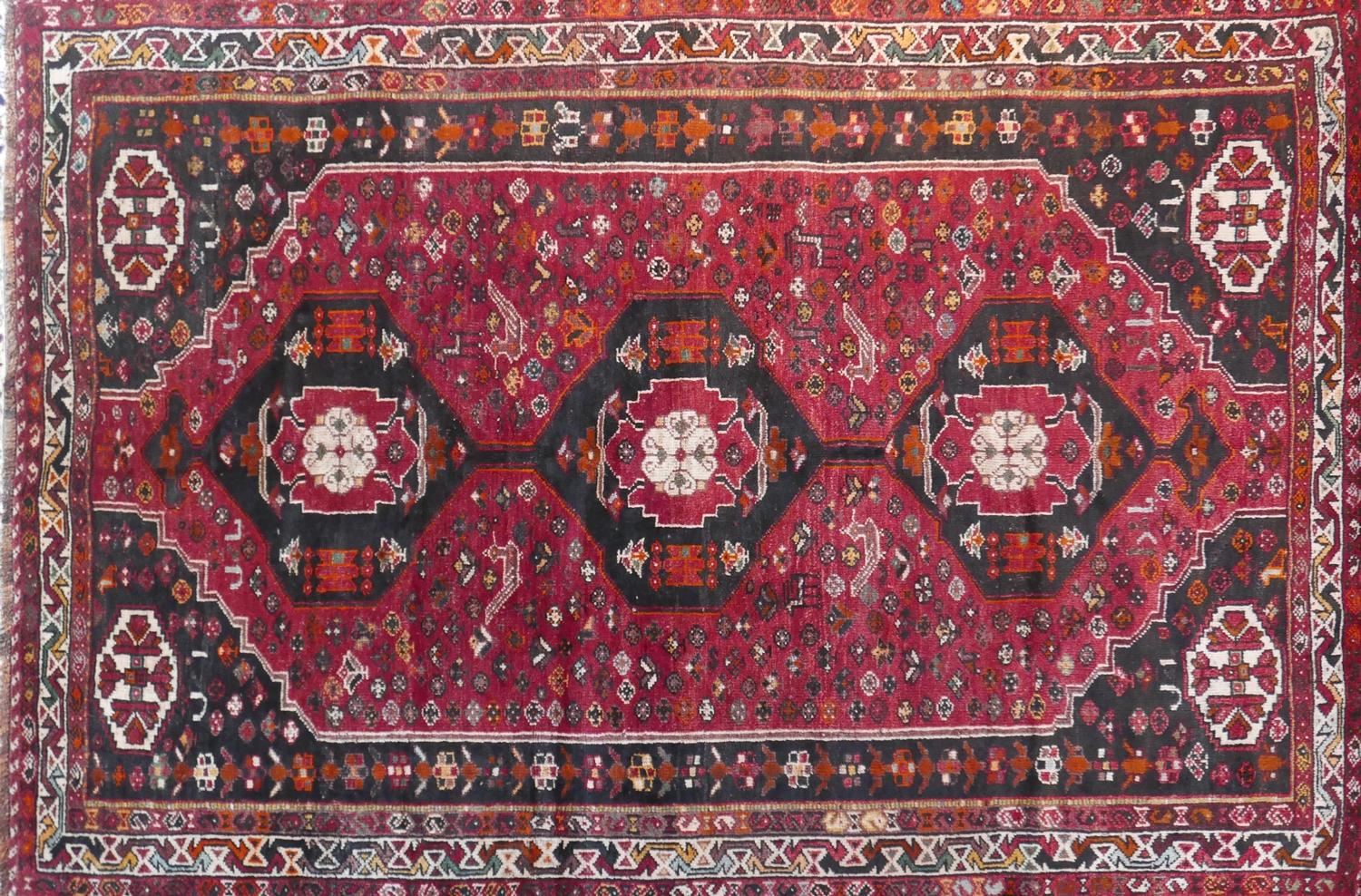 A South West Persian Qashgai carpet, 274cm X 170cm. Triple pole medallion with repeating animal