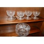 A set of four cut glass sundae dishes together with a crystal fruit bowl