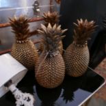 A set of four decorative pineapples in a gilt finish, H.30cm (4)