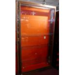 An early 20th Century walnut and bronze display case with fitted glass shelves and red baize