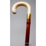 An Edwardian bamboo walking stick by Brigg, with gold plated collar, ivory handle, the collar and