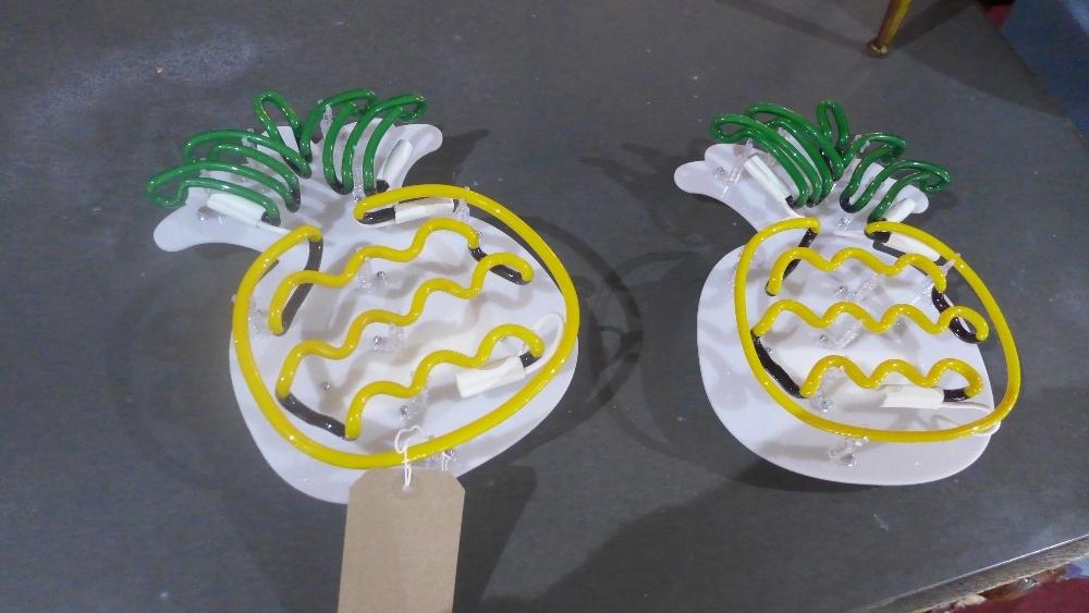 A pair of neon pineapple wall lights (2)