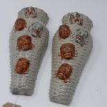 A pair of Japanese wall pockets, c.1920's, of basket form decorated with theatre masks, stamped to