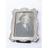 An Edwardian sterling silver easel photo-frame with green velvet backing, circa 1904, Frame: 19 x 14