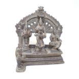 A 19th century bronze Hindu altar piece, depicting three three deities on a shrine with floral