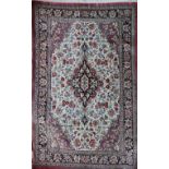 A Persian part silk rug, with a central foliate medallion on an ivory ground with palmettes and