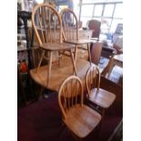 A 20th century Ercol drop leaf dining table and four chairs