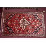 A North West Persian Mahal rug, central ivory medallion on a terracotta field complimented by a