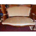 A late 19th/early 20th century French carved walnut sofa, with velour upholstery, raised on cabriole