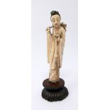 A late 19th century Japanese carving of a lady of a robed lady on a carved hardwood base, H.12.5 W.