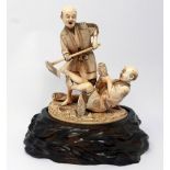 A large Meiji period carved ivory okimono depicting two corn farmers in a field on a textured