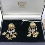 A pair of vintage 1980's designer chandelier-style clip earrings by Askew, composed of a half