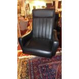 A 1960's high backed swivel office chair, in faux black leather, with four spoke cast aluminium base