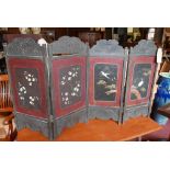 A pair of Japanese two fold lacquered screens with painted decoration and mother of pearl inlay, H.