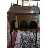 An Art Nouveau mahogany ladies bureau, with urn finials, drop flap above single drawer, raised on