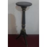 An early 20th century Regency style ebonised pedestal raised on tripod supports, H.110cm