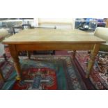 A 20th century rustic pine kitchen table, the planked top raised on turned supports, H.72cm W.92cm