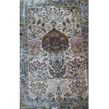 A Persian part silk rug, the central tree of life design on a camel ground within a stylised