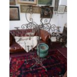 A Moroccan wrought metal floor standing candelabra from Liberty, H.165cm, together with a similar