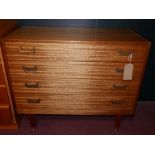 A 20th century G-plan Grange chest of four drawers, raised on tapered legs and brass feet, H.80 W.97