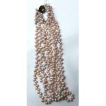 A four-strand lilac-coloured freshwater pearl necklace with white metal and pearl clasp, L.46cm