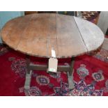 A 19th Century French fruitwood vendange table, the planked circular tilt top raised on