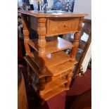 A pair of Indonesian carved teak side tables, with bevelled glass inserts over frieze drawer and