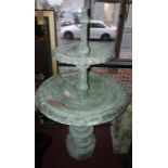 A cast iron two tiered fountain, with floral decoration, raised on stepped circular base, H.140cm