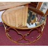 A contemporary circular low table, with mirrored top over gilt metal base, H.34cm Diam.78cm