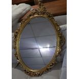 A Rococo style oval gilt mirror, 86 x 83cm