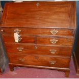 A Georgian mahogany bureau, the fall front enclosing fitted interior over dummy drawer and two short