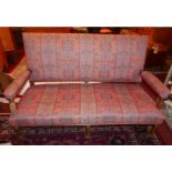 A Victorian Aesthetic hall bench, upholstered in a floral decorated fabric, raised on turned legs,