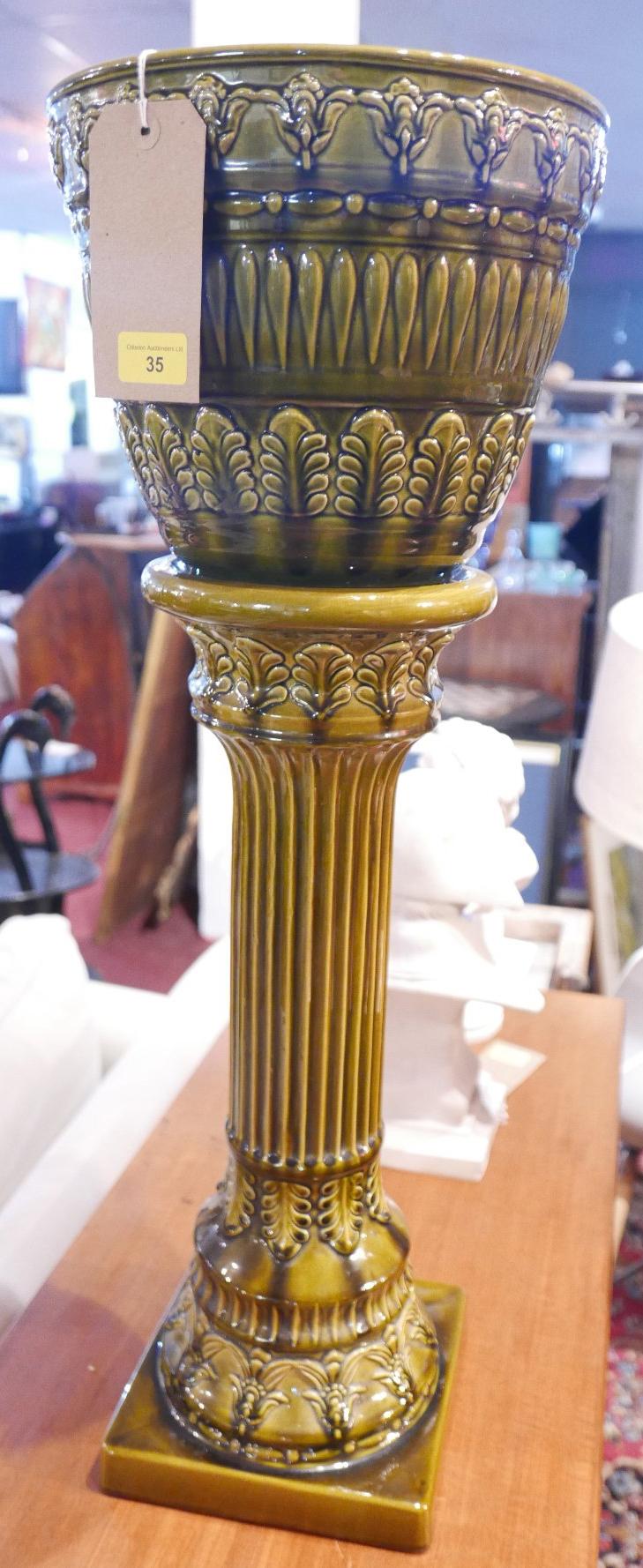 An early 20th century West German green glazed ceramic jardiniere on stand, H.80cm