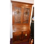 A 20th century oak bureau bookcase, with two lead stained glass doors, H.216 W.100 D.46cm